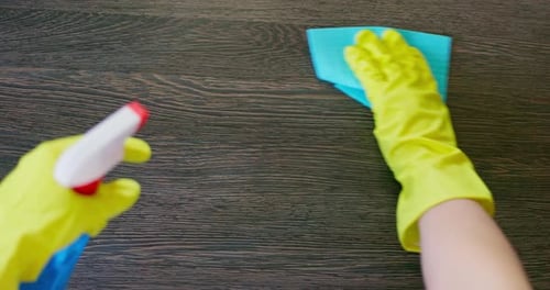 Hands Cleaning Dark Brown Wooden Surface