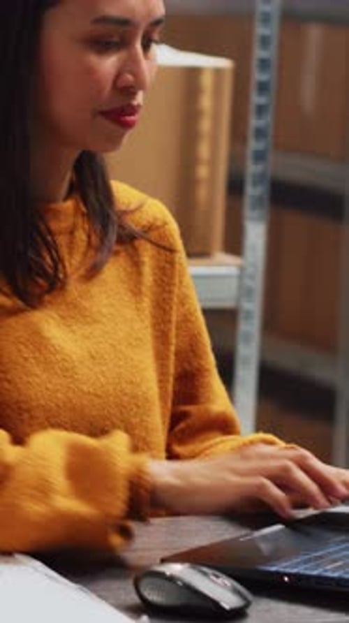 Vertical Video Female Entrepreneur Checking Stock Products on Pc