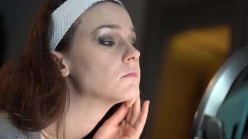 Woman Applying Makeup With Sponge, Close Up