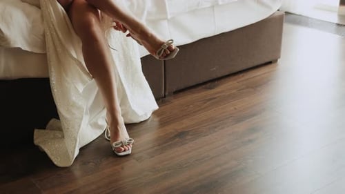 Elegant Woman Putting on High Heel Shoes
