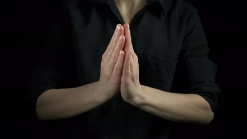 Praying Lady Hands Against Black Background