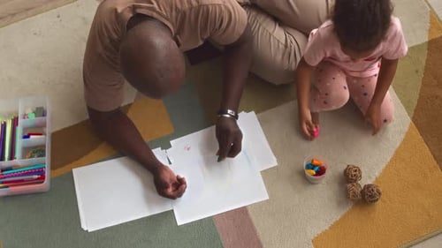 Father and Daughter Drawing Together Top View