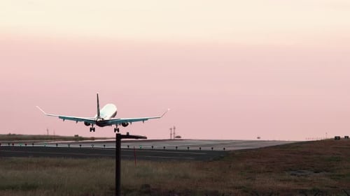 Jet airliner landing on runway.