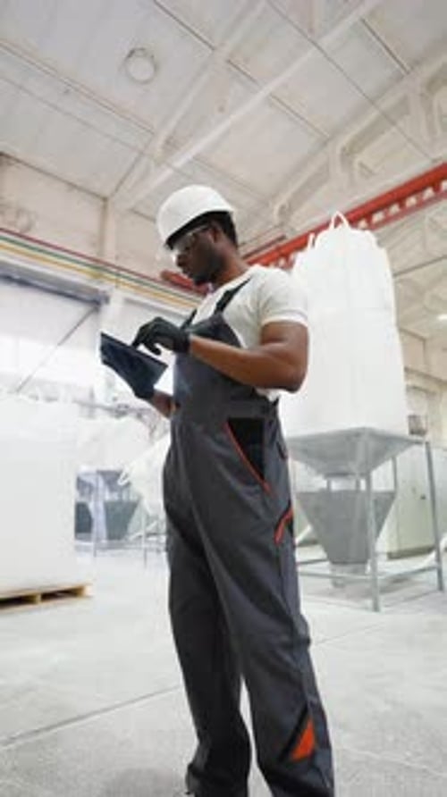 Worker of Pvc Windows Factory a Tablet on Production Line Vertical Video