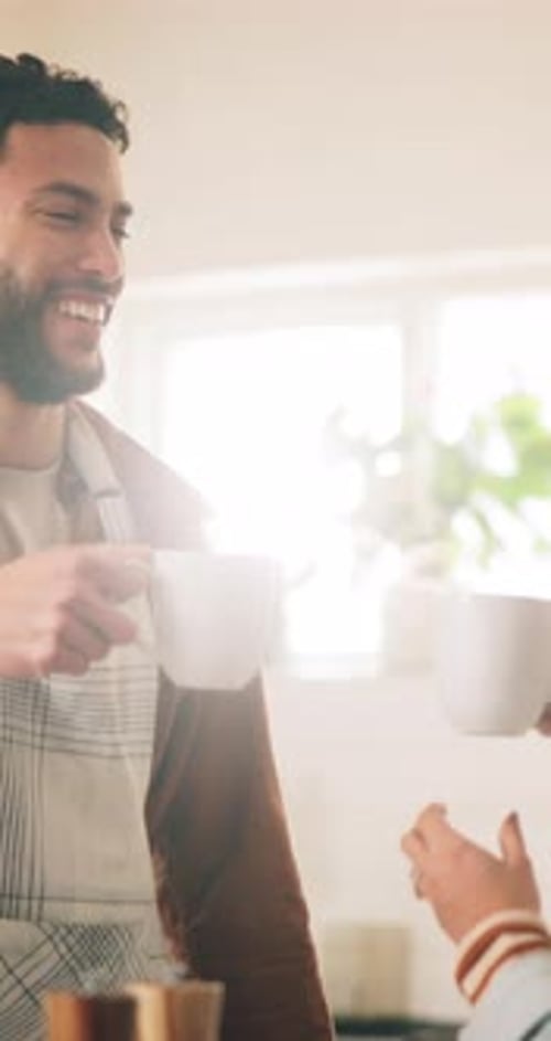 Man toasting with mug in bright kitchen