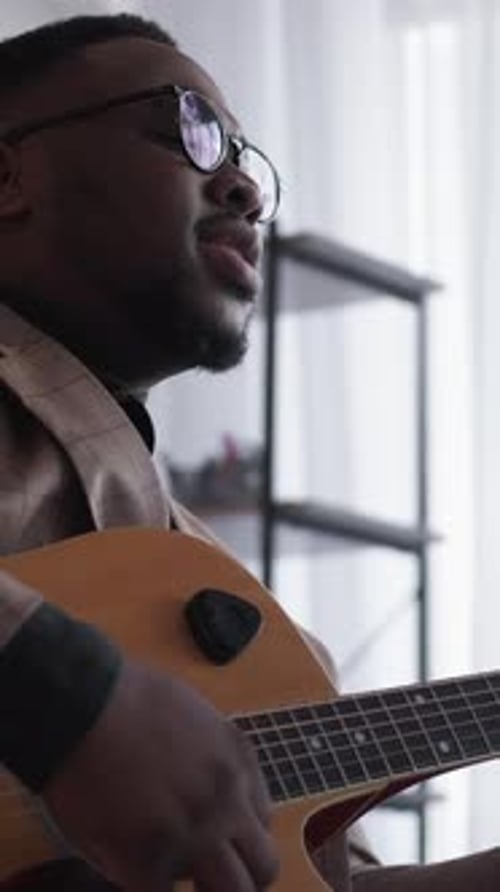 Man Plays Guitar and Sings a Song