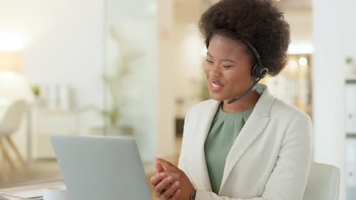 Smiling Woman Working at Computer with Headset