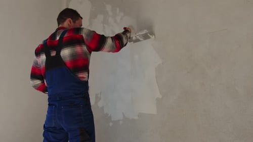 Man Plastering a Wall in an Interior Room