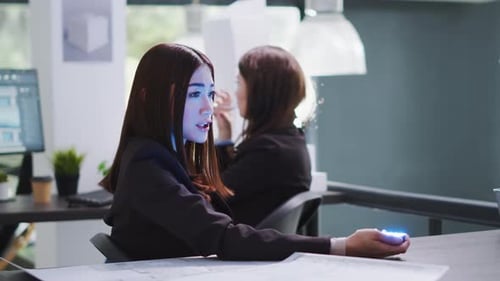Developer Talking to Consultant on Holographic Projection
