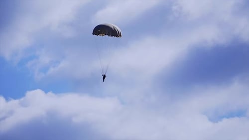 Person Parachuting from the Sky on Sunny Day