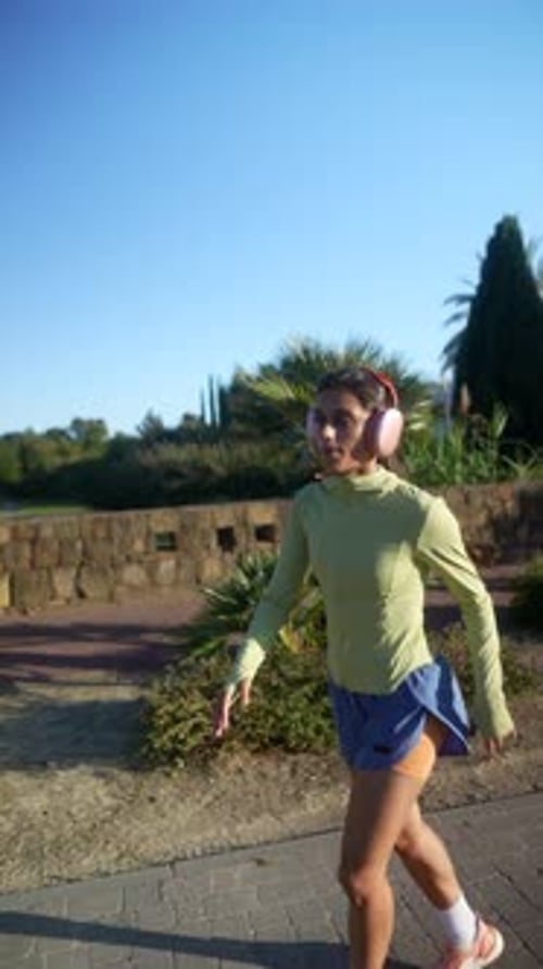 Woman Exercises in Place in Urban Park