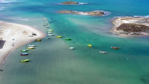 Small Fishing Boats anchored in a shallow lagoon, with packed Fish net onboard, Aerial view