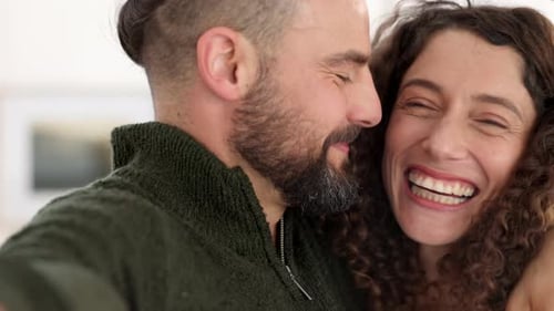 Affectionate Couple Laughing and Embracing Indoors