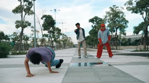 Three Young Men Dancing in Urban Park