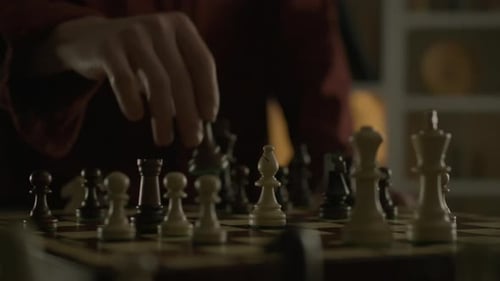 Strategic game of chess. An experienced player deftly moves a piece, moving it to a new square on