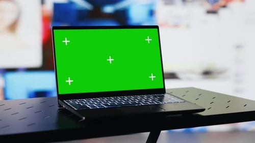 Laptop Shows Green Screen Mockup Next to Modern Web Design
