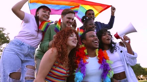 Diverse Group Celebrates Pride Day with Rainbow Flags