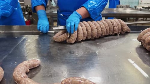 Close up of sausages production process at the meat factory