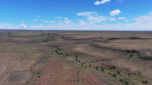 Scenic Aerial Pan Over Vast Wild Savanna and Dry Riverbed of Africa Revealing Untamed Wilderness of