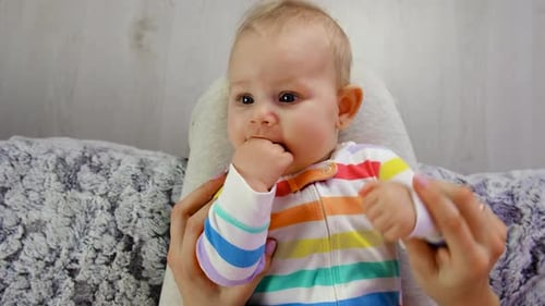 Cute Baby Being Held by a Woman