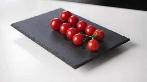 Slow Motion View of Cherry Tomatoes Falling on the Plate Fresh Vegetables Demonstration Organic Food