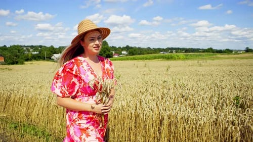 A Woman in a Romantic Mood Walks Among a Wheat Field