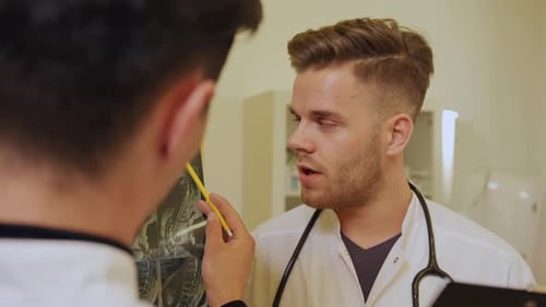 Two Young Doctors Examining an X-Ray