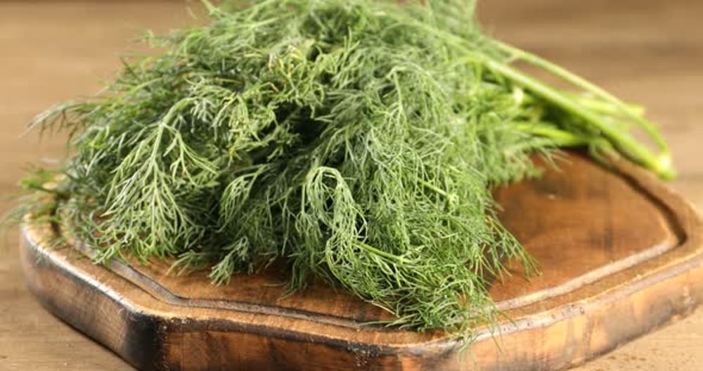 Spraying water onto fresh dill at wooden table, closeup, Food Stock ...
