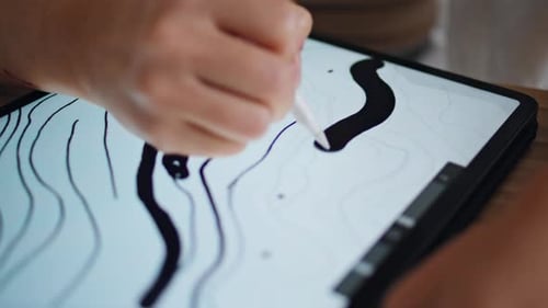 Artist Drawing Line Art on Tablet Close Up