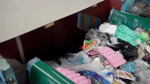 Plastic Waste on Conveyor Belt in Recycling Facility