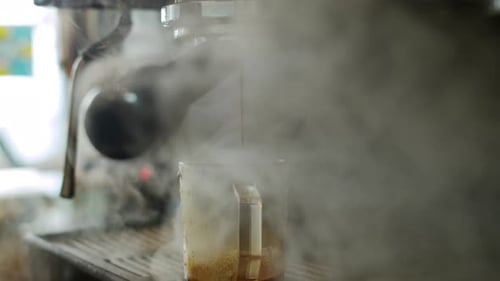 Barista making coffee and steam