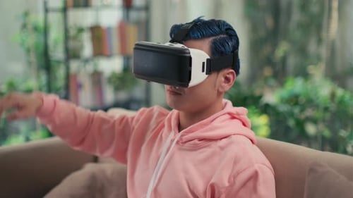 Young Adult Using Virtual Reality Headset at Home