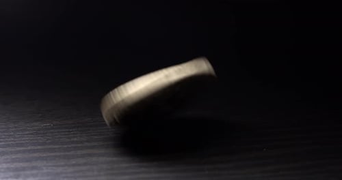 Bitcoin Spins and Stops on Dark Wood Surface