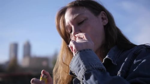 tired of smoking cigarettes Tired, homeless woman lights her cigarette in close up. Part of a series in slow motion where she sm tired of smoking cigarettes Tired, homeless woman lights her cigarette in close up. Part of a series in slow motion where she sm