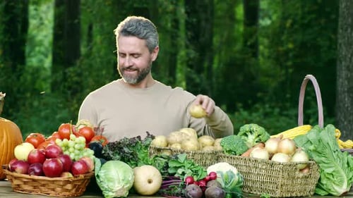 Bearded Man with Fresh Vegetables from Farm Harvest