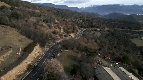 Drone Captures a Motorbike Travelling Along a Mountain Road