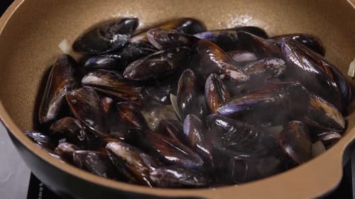 Steaming Hot Gourmet Black Mussel with White Wine in Golden Pan, Fresh Seafood Black Mussels