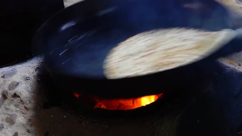Flatbread Cooking in a Wok Over Open Fire