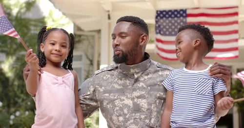 Soldier Father and Children Proudly Wave American Flags
