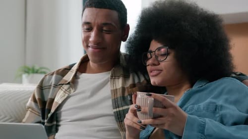 Couple Relaxing at Home with Laptop