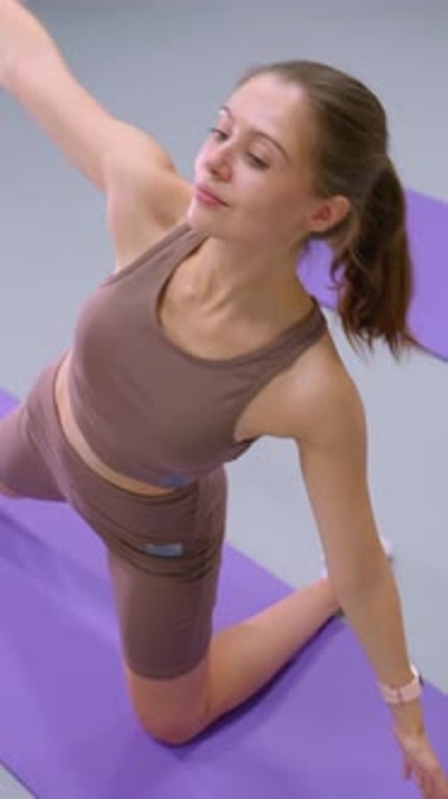 Aerial View of Person Stretching on Purple Yoga Mat