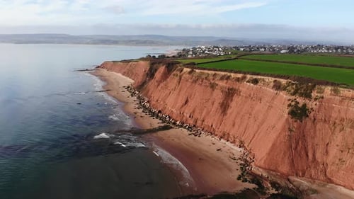 Aerial View Of Orcombe Cliff Coastline On Sunny Day In Exmouth. Dolly Right