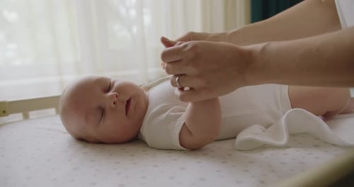 Adorable Baby Lying on Changing Table in Nursery