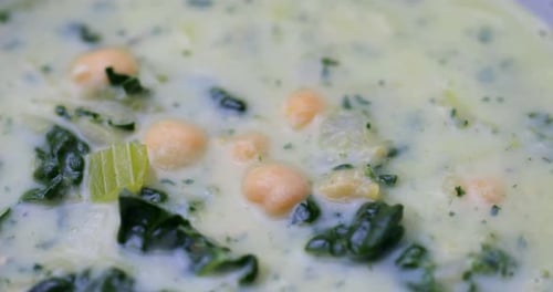Close up of creamy vegetable soup. Vegan bowl food. Plant based cooking shot in 4k. Shallow depth of