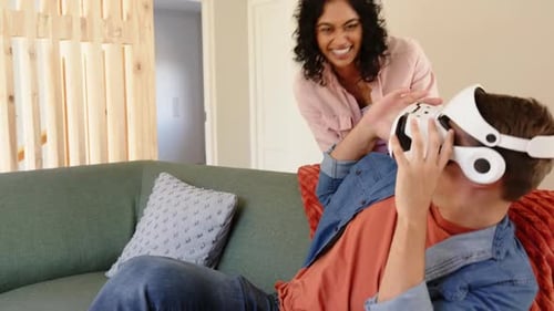 Playful Couple with VR Headset in Modern Home