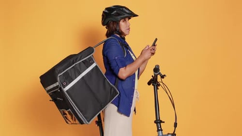 Delivery Woman With Bicycle Using Phone