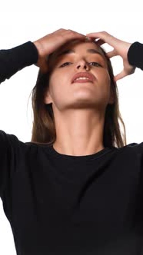 Woman Styles Hair in Updo Fashion Portrait