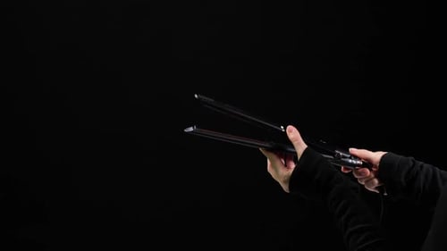 Hands Holding and Operating Hair Styling Tool