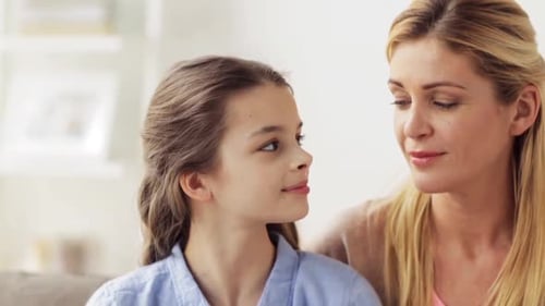 Happy Girl and Woman Smiling Lovingly Indoors