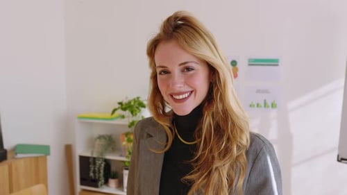 Portrait of Young Businesswoman Looking at Camera Standing in the Office